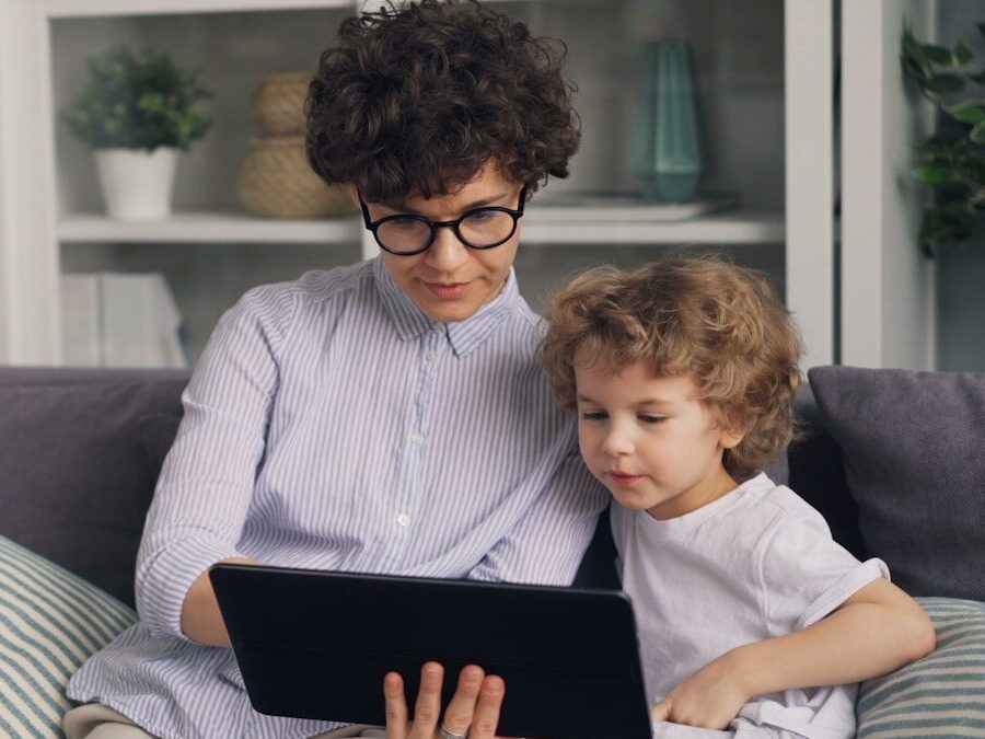 a woman sitting on a couch with a child on her lap